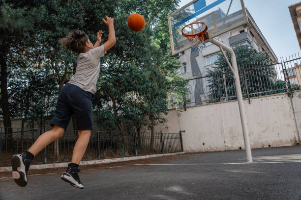istock Young boy playing basketball in garden. 2164776549