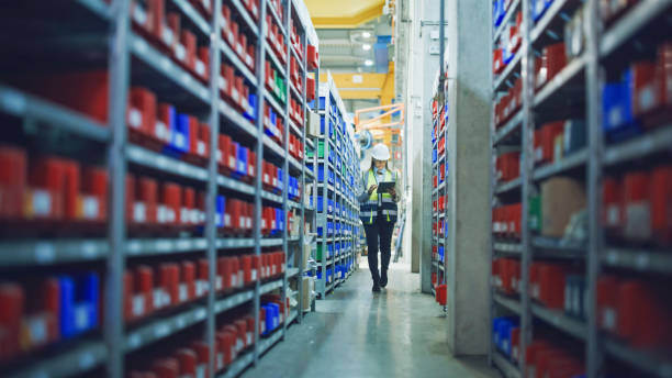 istock Female Manager Using Tablet PC at Aisle in Warehouse 2164777234