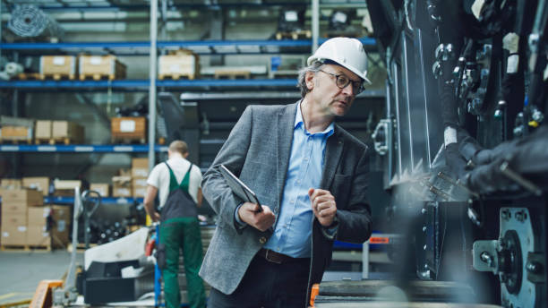 istock Male Engineer with Tablet PC Examining Machinery 2164777281