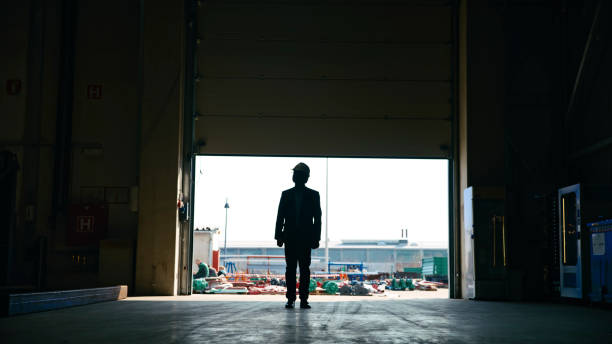 istock Full Length of Engineer Looking at Distribution Warehouse During Sunny Day 2164777296