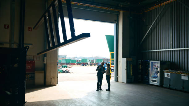 istock Manger Discussing with Inspector over Industrial Equipment at Warehouse 2164777346