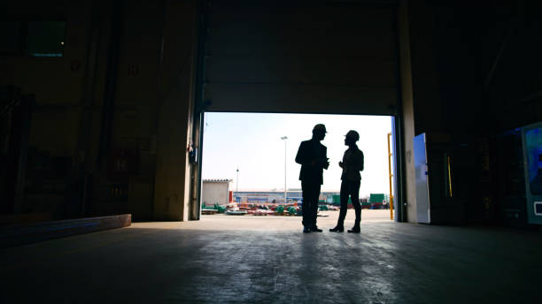 istock Managers Discussing while Standing at Entrance of Storage Room on Sunny Day 2164777363