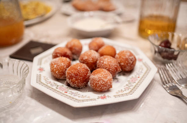 Close-up of a plate of delicious koesisters sitting on a dining table for iftar during Ramadan