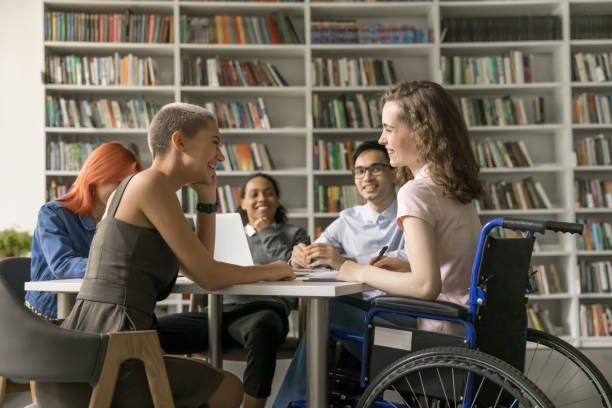 istock Group of students and girl with disability engaged in teamwork 2164778355