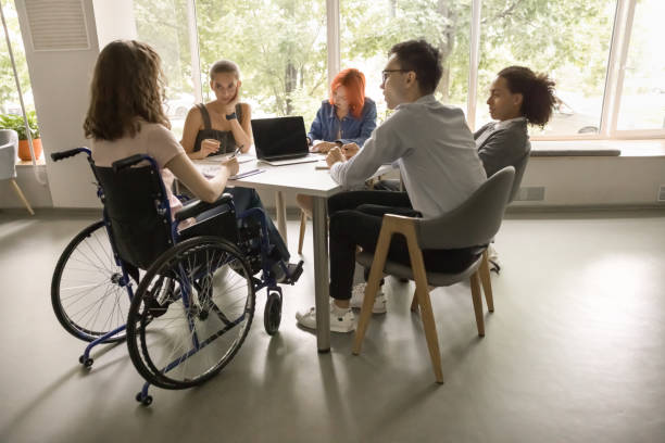 istock Five students and girl with disability studying in classroom 2164778993