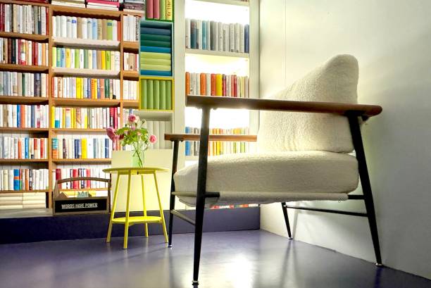 istock Armchair in the illuminated library 2164780064
