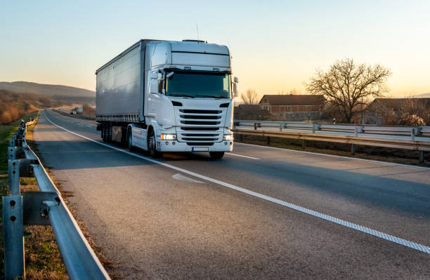 istock Big white semi trailer truck on a highway 2164781325