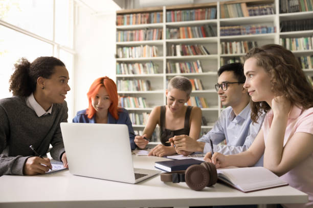 istock Multiethnic students convene in library involved in communication and teamwork 2164781598