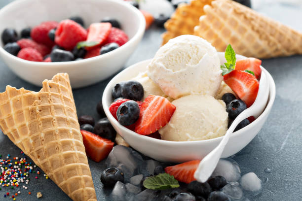 istock Vanilla ice cream scoops with berries 2164782124