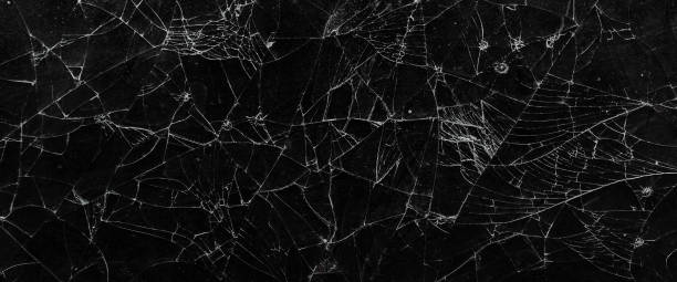 istock Pattern on cracked glass. damage to glass. broken or damaged background on glass wall 2164782609