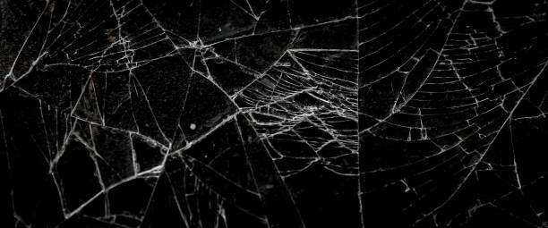 istock Pattern on cracked glass. damage to glass. broken or damaged background on glass wall 2164782613