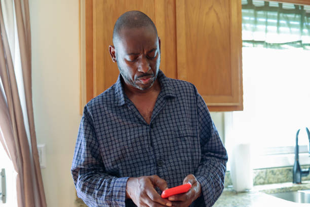 istock A portrait of a black man texting on a mobile phone 2164783021