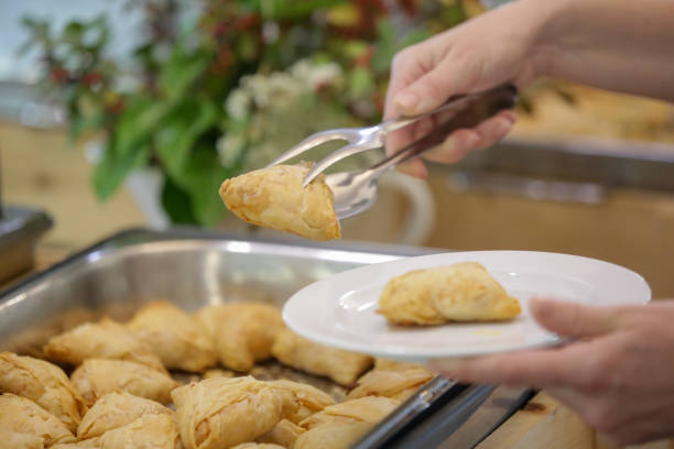 istock Woman taking food from a buffet line 2164783098