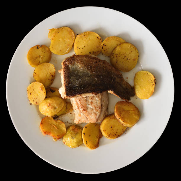 Grilled salmon with baked potatoes on white plate