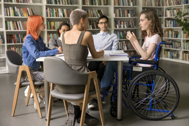 istock Group of diverse students listening schoolmate with physical disability 2164783931