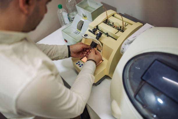 istock Careful handling of glasses frame in optical machine. 2164784136