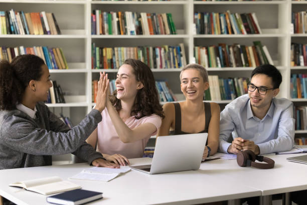 istock Happy students giving high five celebrate good teamwork results 2164785261