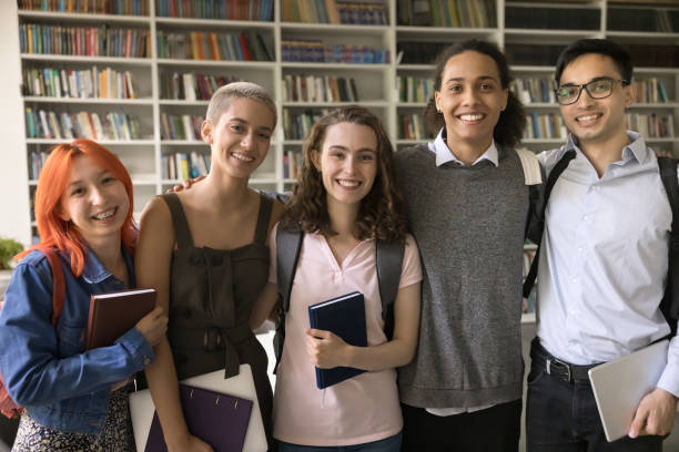 istock Five smiling attractive multiethnic schoolmates posing looking at camera 2164785322