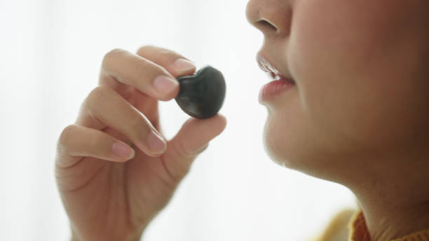 Woman eating a cherry fruit.