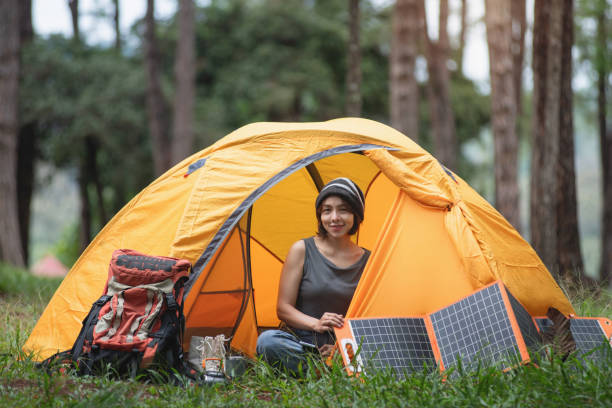 istock Asian female backpacker sitting at her tent at campsite 2164787155