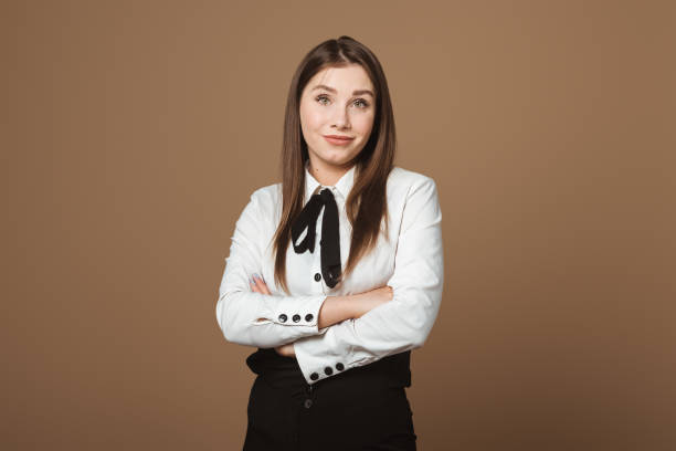 istock Attractive Brunette Young Woman Standing with Crossed Arms and Unhappy Expression. Concept of Discontent, Disapproval, and Non-verbal Communication 2164788607