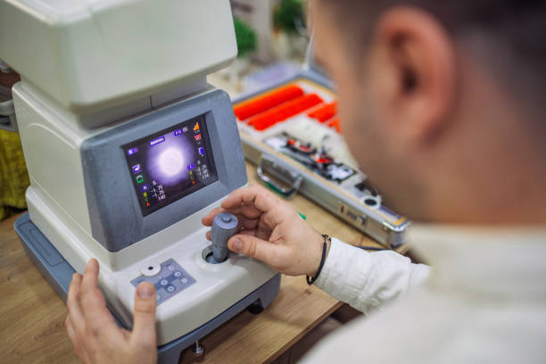 During an eye exam, a professional precisely operates the joystick of an autorefractor, ensuring an accurate measurement of the patient's visual acuity in a state-of-the-art optometry clinic.