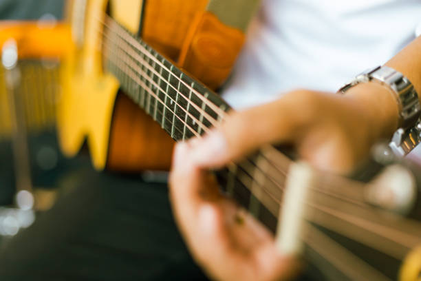 Man playing white guitar