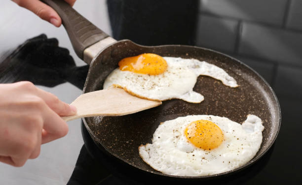 istock Fried Eggs In A Frying Pan In Close Up View 2164792517
