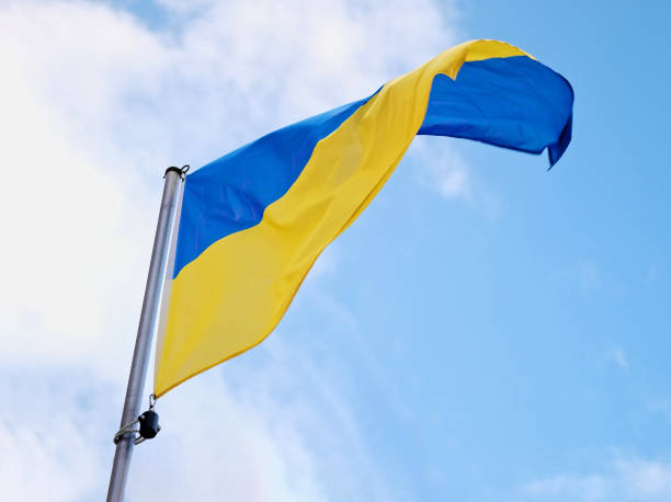 istock Ukraine'S National Flag Unfurls On Flagpole 2164795554
