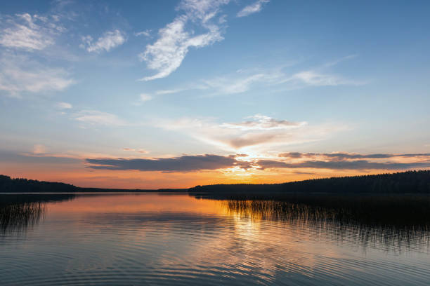 istock Dramatic sunset landscape with colorful clouds over still lake 2164796602