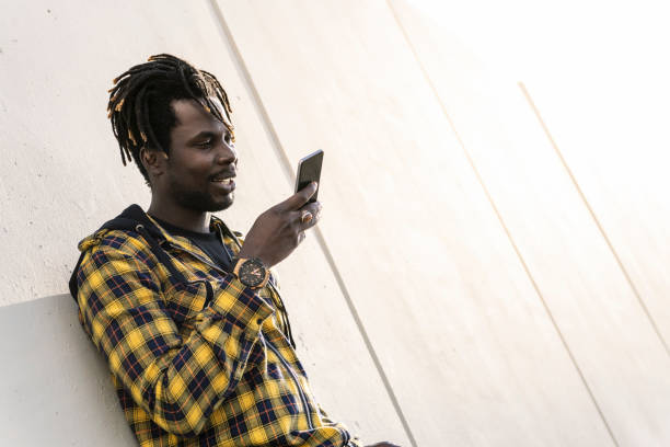 istock black man recording a voice message on his phone 2164798483