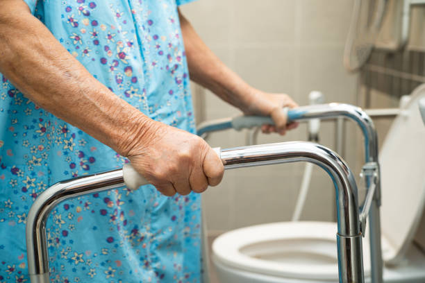 istock Asian elderly woman patient use walker and toilet bathroom handle security in nursing hospital, healthy strong medical. 2164799521