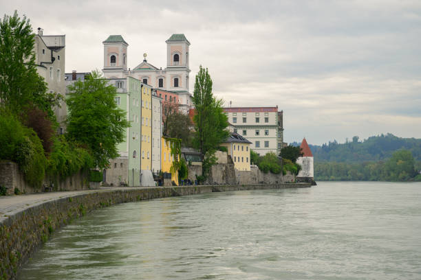 Passau, Germay - April 15, 2024: River Inn church and tower on a cloudy day in springtime