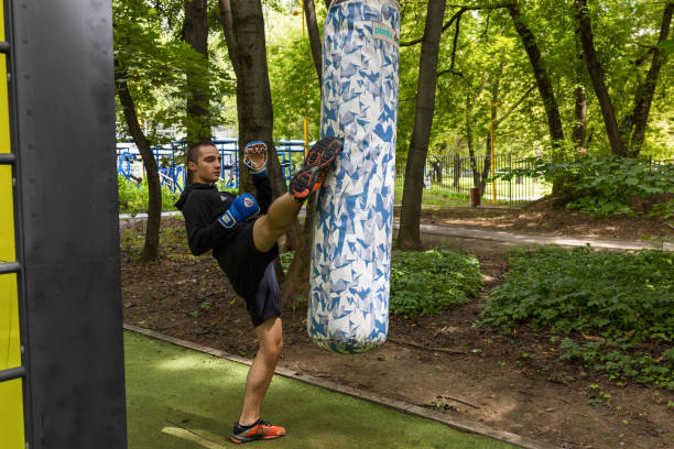 Moscow, Russia – July 31, 2024:  MMA fighter trains in the park.