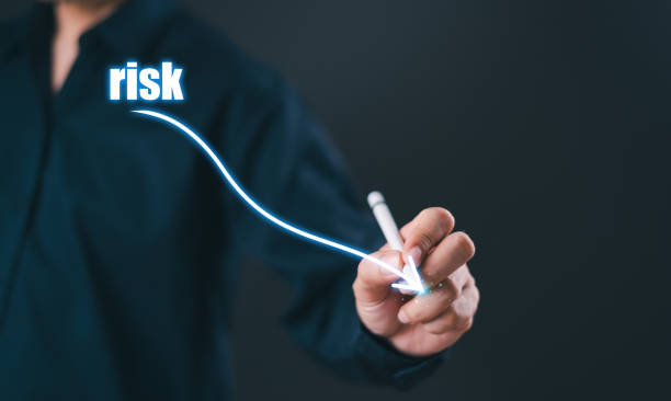 Low risk business control level concept. Businessman use pen to analyze risk opportunities, plan business risk level indicators. Lower rating to high digital virtual measure. Risk management financial
