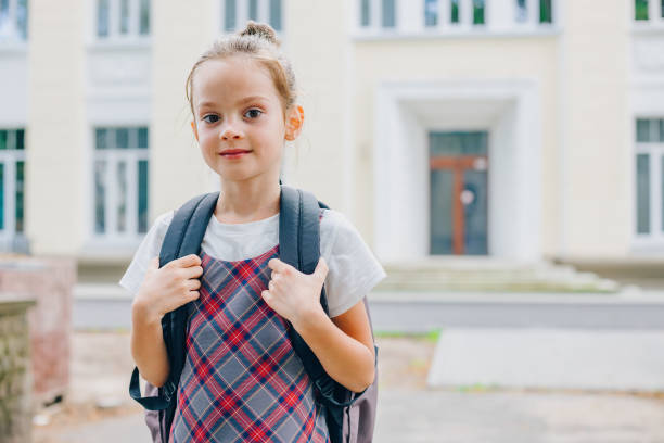 istock Young schoolgirl smiling and holding her backpack straps 2164803314