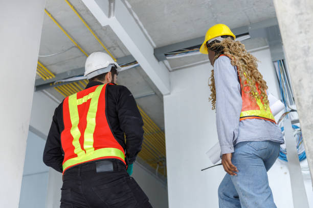 istock Construction civil engineer man and woman African American use tablet check quality of work in construction site. Team of various nationalities working inspecting infrastructure building progress. 2164807210