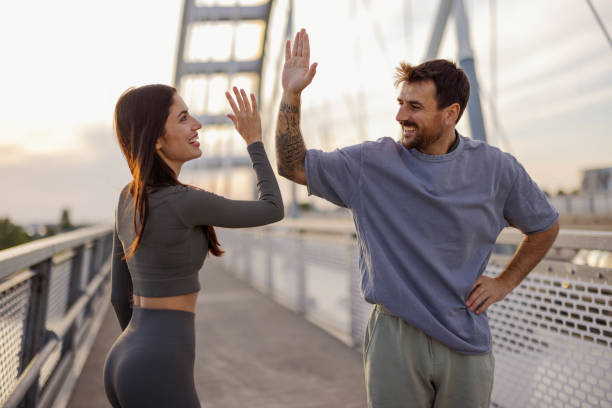 istock Caucasian runners giving high five 2164807298
