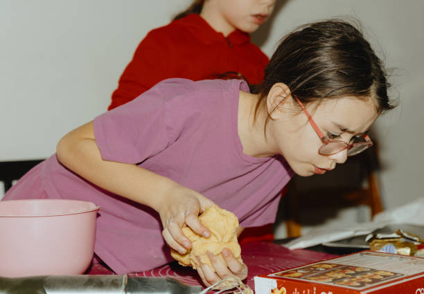 istock One girl bakes cookies while studying the instructions. 2164808113