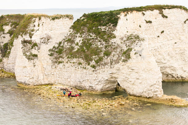 Dorset, UK - September 13, 2023. People sea kayaking around the Jurassic Coast. Old Harry Rocks, Studland, Dorset, UK