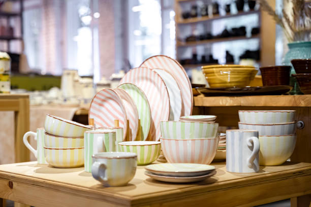 Ceramic tableware is displayed in close-up on wooden shelves in the store