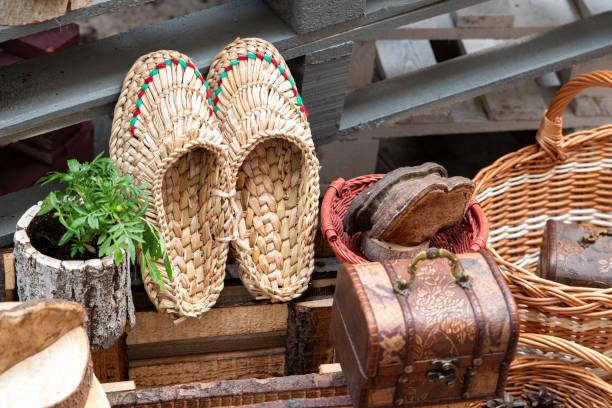 Woven bast shoes at the flea market. Handmade work