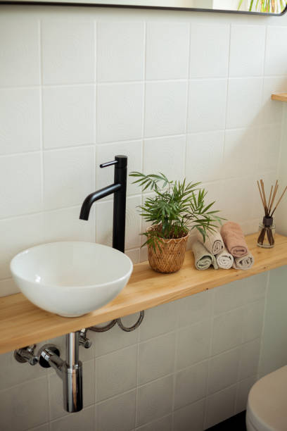 istock Bathroom in black and white. Home decor. Sink, hand towels, diffuser, house flower. Cozy. 2164810990