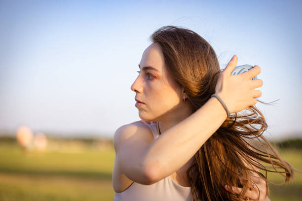 istock Young athlete woman is combing her hair. 2164812286