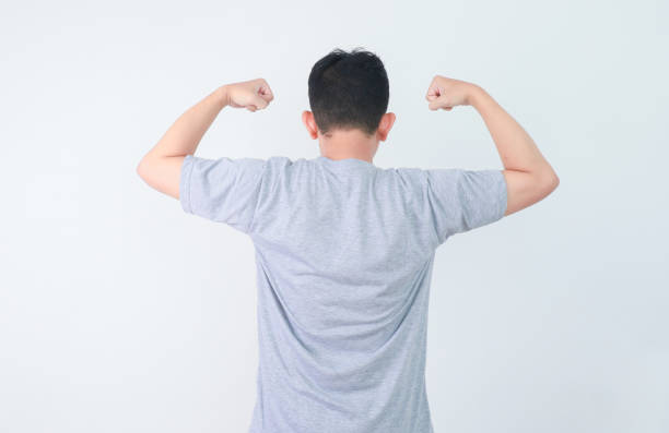 istock Back view of a man clenching both hands showing success gesture 2164813286