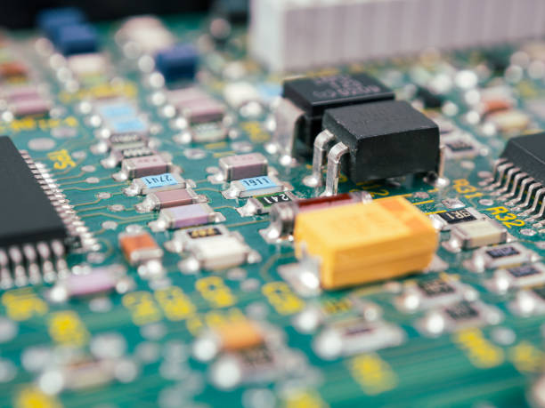 istock Close-up of microcircuits and components: chips, diodes and capacitors on a printed circuit board, revealing the world of electronics 2164814359