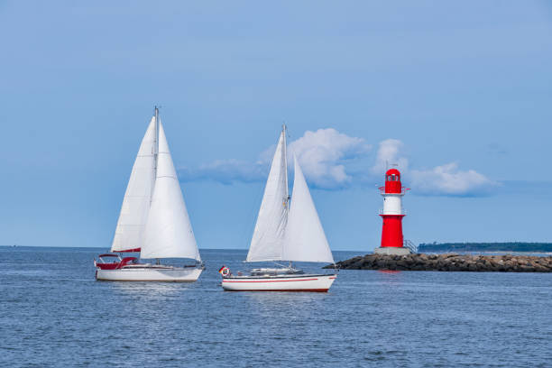 Two sailboats arrive in the port of Warnemünde
