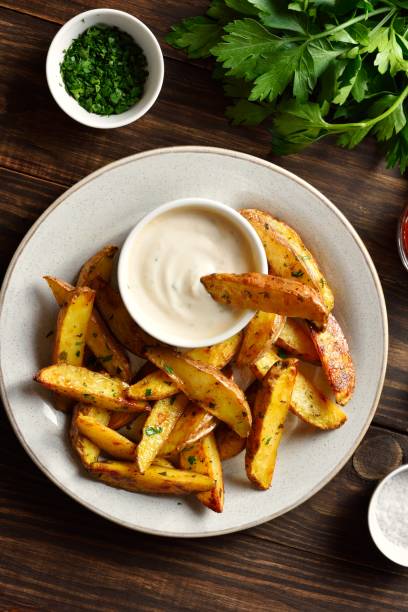 istock Baked potato wedges with sauce 2164816171