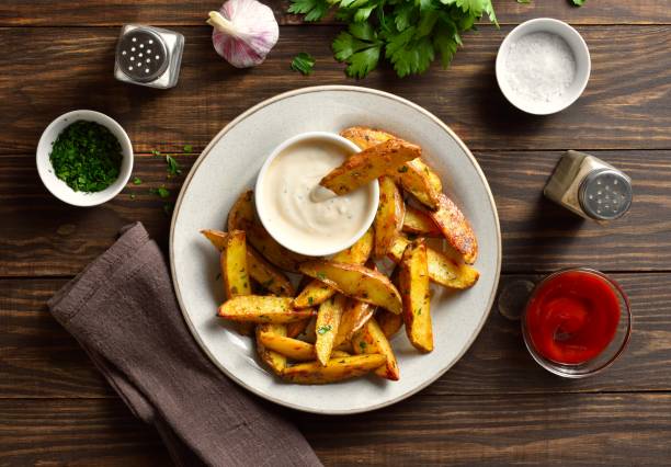 istock Baked potato wedges with sauce 2164816229