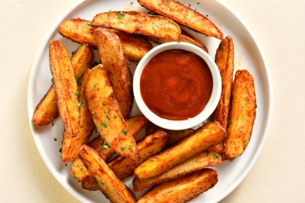 istock Oven baked potato wedges with sauce 2164816249